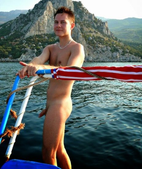 Cute nude boy on a boat