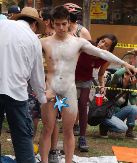 Naked boy getting body painted