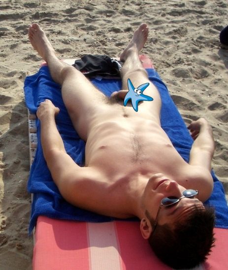 Nude beach man sunbathing