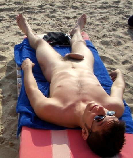 Nude beach man sunbathing