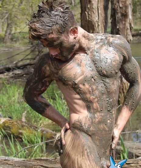 Nude boy covered in mud