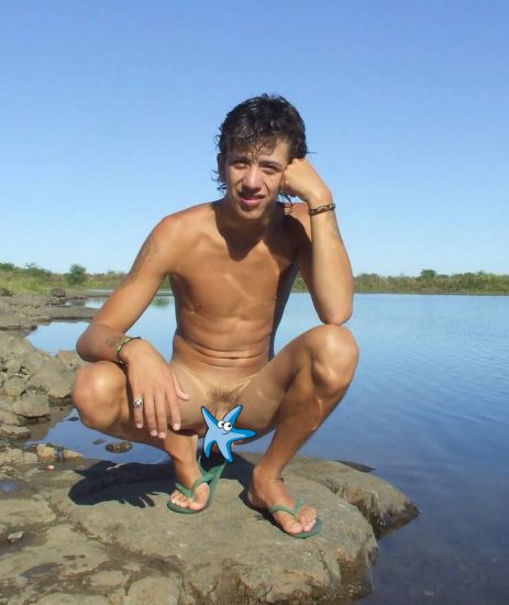 Nude Latin boy by a lake