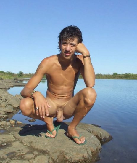 Nude Latin boy by a lake