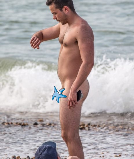 Nude man on a pebble beach